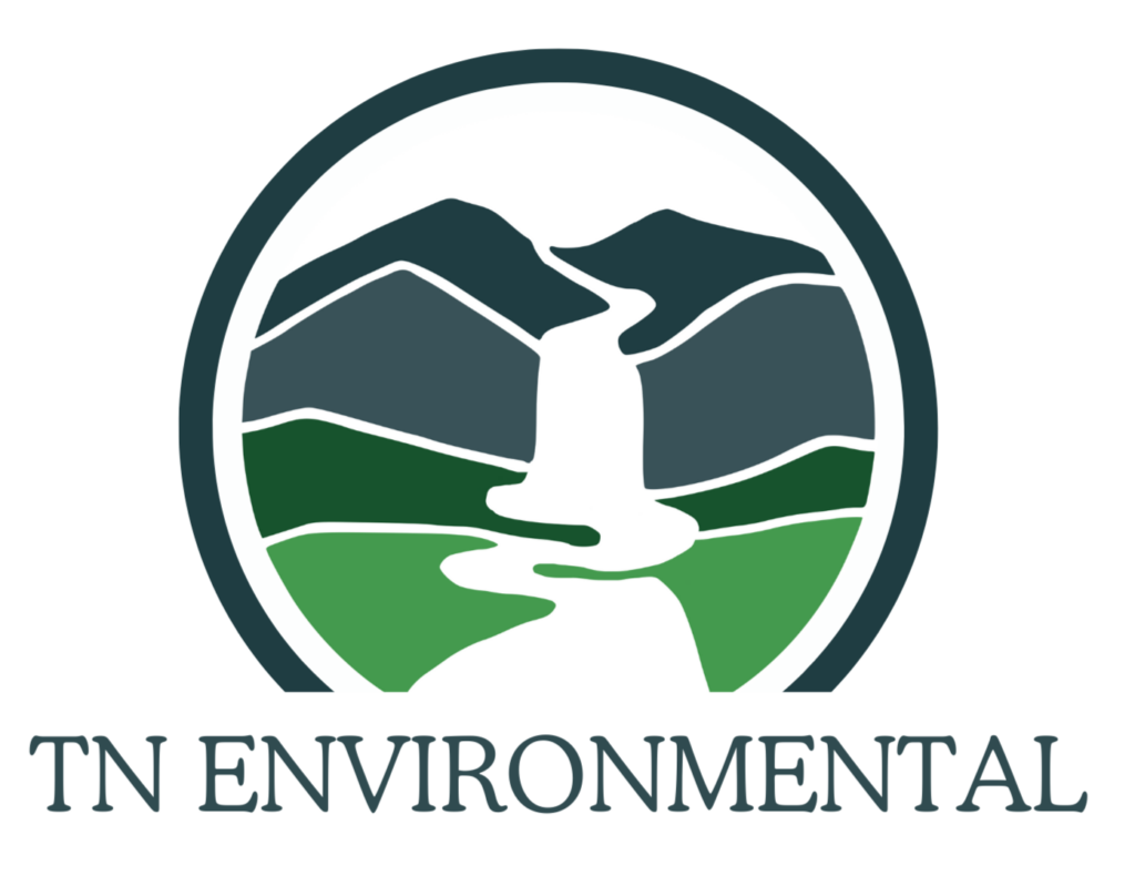 TN Environmental logo. A teal band encircles three layers of twin peaks which graduate from blue mountains on the horizon to a green rolling field in the foreground. A white stream flows down the middle of the landscape, meandering between the top peaks, cascading in a waterfall through the layers of ridges and finally forming a river flowing across the green field.